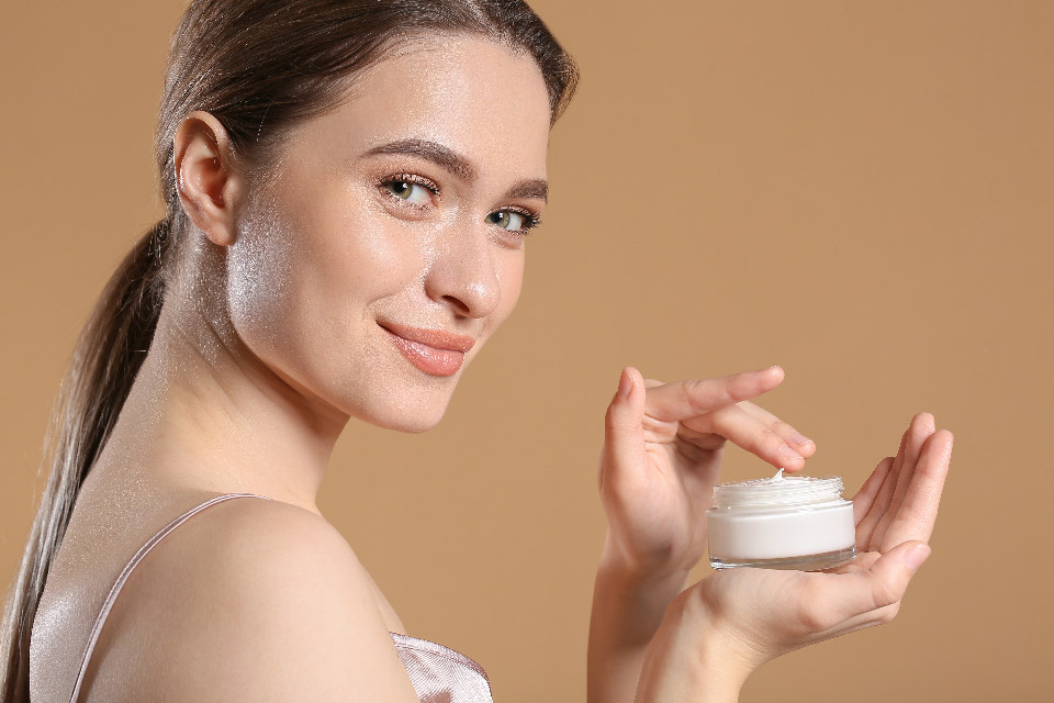 Woman holding a jar of cream
